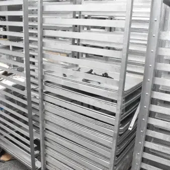 Two commercial pan transport racks with wheels, containing 68 baking pans, shown in used condition with visible labels.