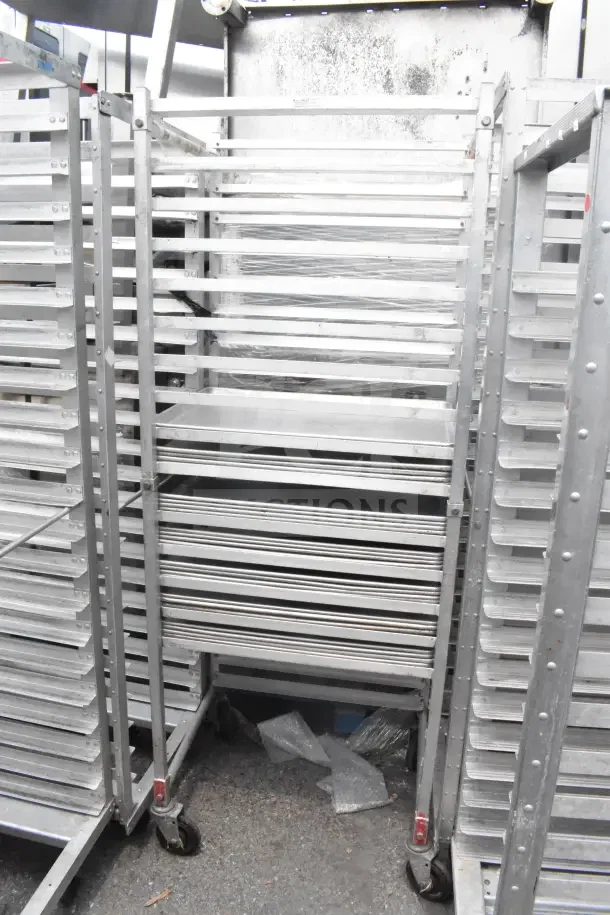 Two commercial pan transport racks with 68 baking pans, durable metal construction, on casters for mobility.