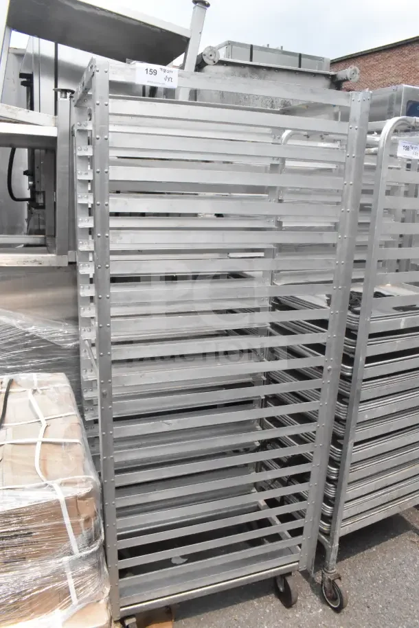 Two commercial pan transport racks, metal, multiple shelves, on casters for mobility, used condition, auction item 159 labeled.