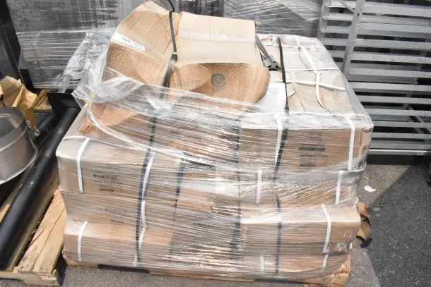 Plastic-wrapped pallet of 15 new scratch and dent items, including table base pieces. Boxes show handling marks.