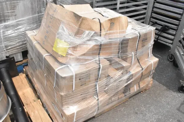15 new scratch and dent items, including table base pieces, wrapped on pallet, visible boxes and straps.