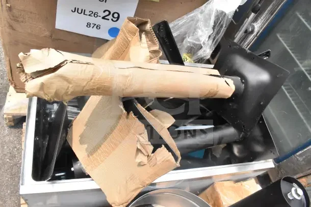 12 new scratch and dent items including table base pieces and ice bin; visible packaging, tagged "JUL26-29 876".