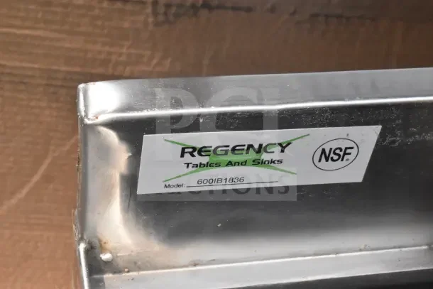 Regency stainless steel piece with scratch, showing "Tables and Sinks" label, model 600IB1836, NSF certified.