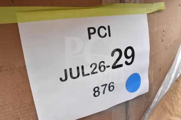 Package label with "PCI JUL26-29 876" displaying auction details. Includes brand new scratch and dent items.