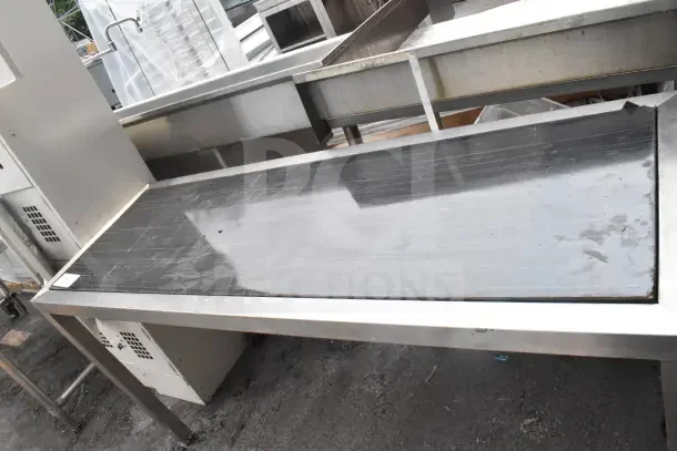 Black and Chrome Finish Table with sleek surface. Features sturdy construction. Minor surface wear visible. Ideal for modern decor.