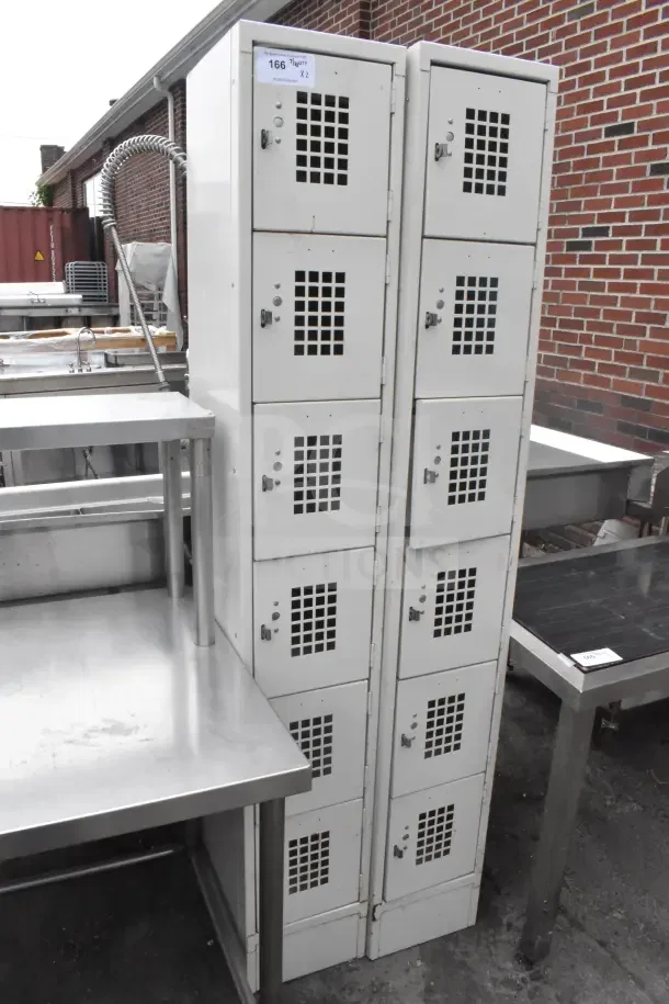 Two-tier tan locker with 6 cubbies per column, good condition, numbered tag visible indicating auction details.