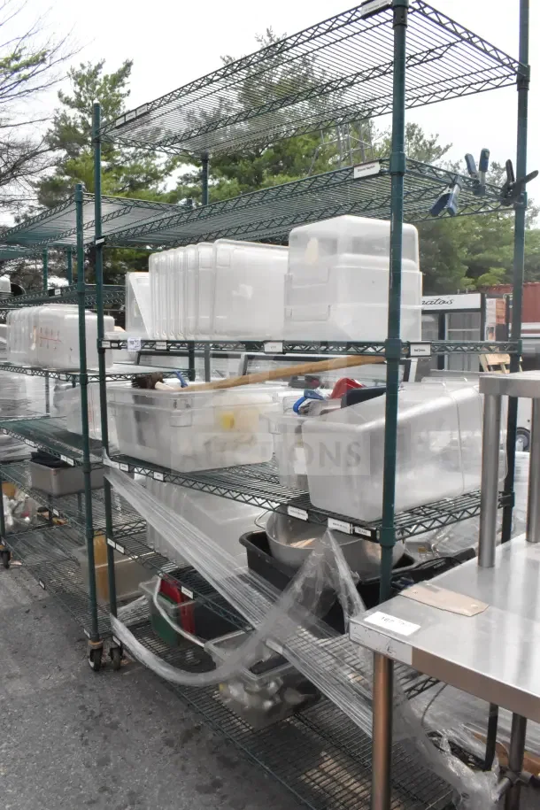 Green finish 5-tier wire shelving unit on casters with contents including plastic bins. Buyer must dismantle for shipping.