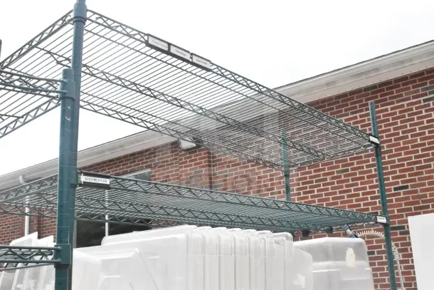 Green 5-tier wire shelving unit on commercial casters, includes bins, labels indicate contents, buyer must dismantle.