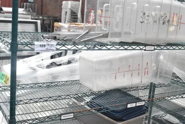 Green 6-tier wire shelving unit on commercial casters, includes clear storage bins. Buyer must dismantle. Freight charges apply.
