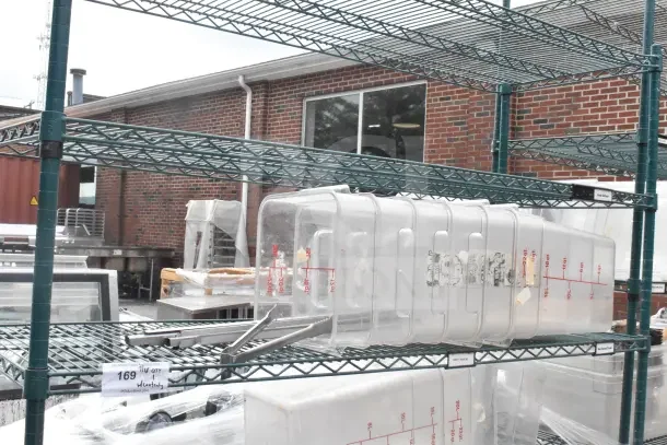 Green 6-tier wire shelving unit on casters, includes bins. Buyer must dismantle. Consider freight charges.