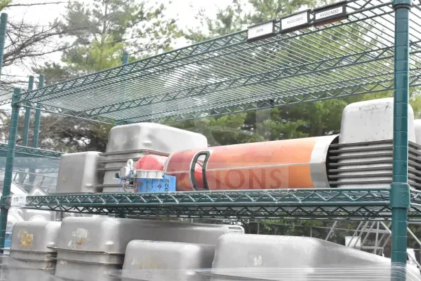 Green 6-tier wire shelving unit on commercial casters, includes drop-in bins, rugged design, requires buyer dismantling.