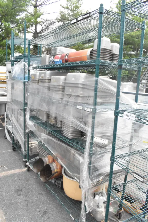 Green 6-tier wire shelving unit on casters with contents, including drop-in bins; requires buyer dismantling.