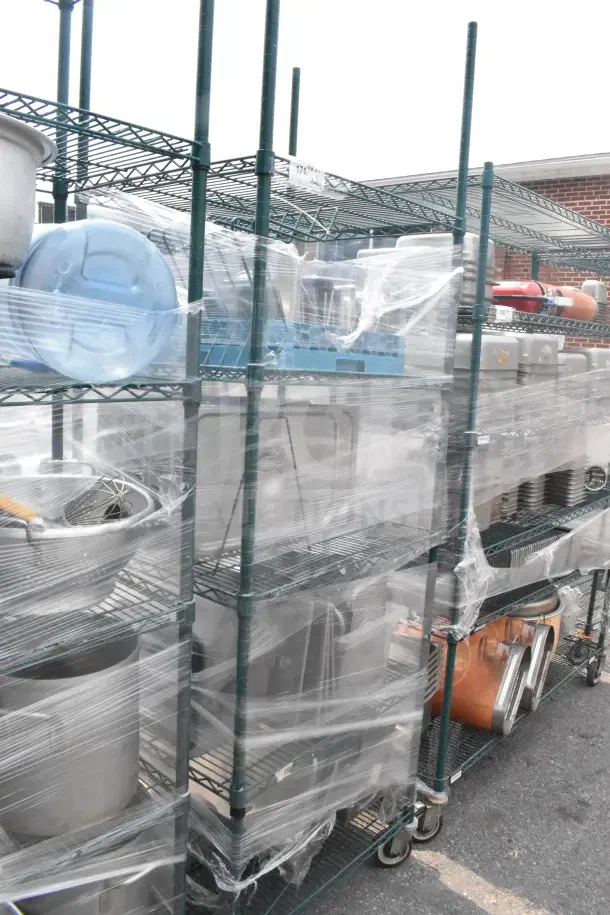Green 5-tier wire shelving unit on casters with various contents, including drop-in bin lids. Buyer must dismantle.