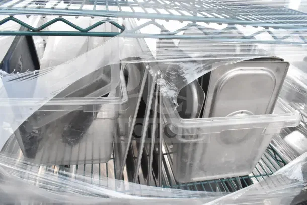 Green 5-tier wire shelving unit on casters with contents, including drop-in bin lids. Dismantling required for removal.