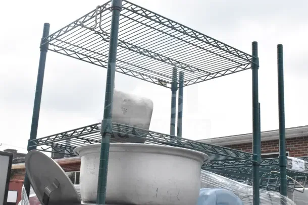 Green 6-tier wire shelving unit on casters with utensils and colander. Dismantling required. Consider freight charges.