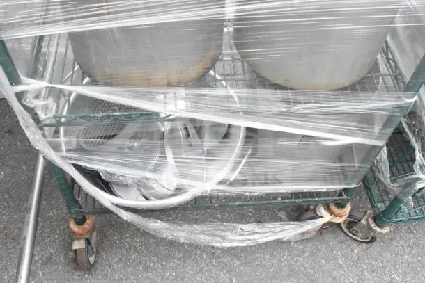 Green finish 6-tier wire shelving unit on casters, wrapped, includes utensils, colander, requires dismantling for shipping.