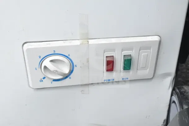 Igloo FRF520-SM chest freezer control panel, showing temperature dial and power lights. Minor wear visible.