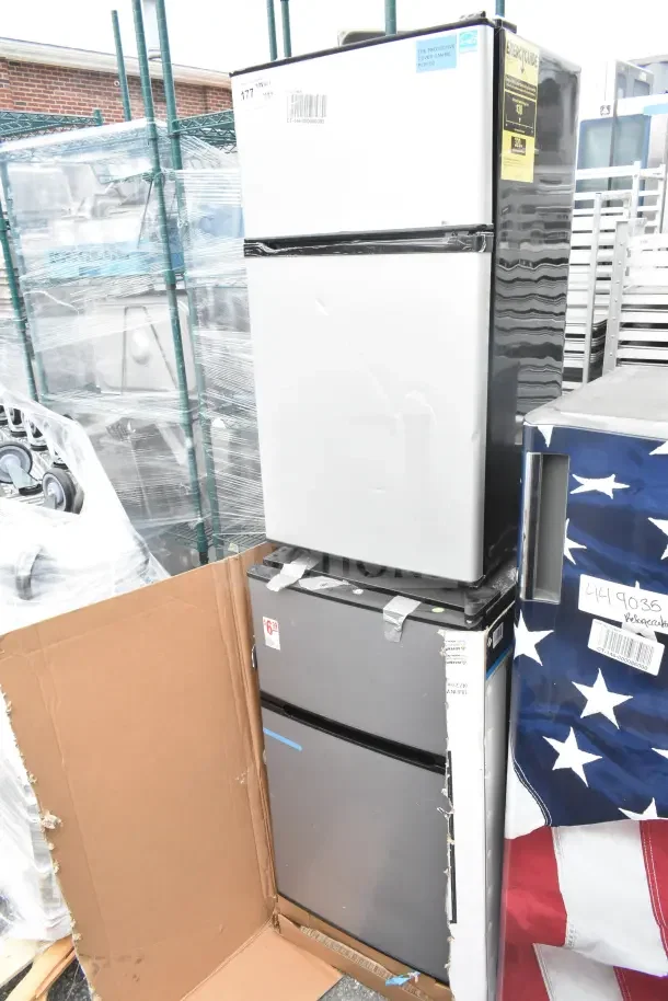 Four mini coolers including Galanz and LG, 115 volts, 1 phase. Auction lot. Slight wear visible, stacked arrangement.