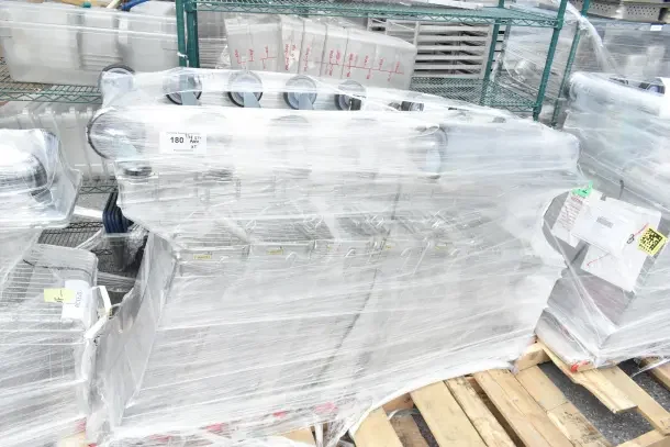 5 new Regency 6.3 Cu. Ft. supermarket shopping carts, wrapped, slight scratches, stacked on pallet.