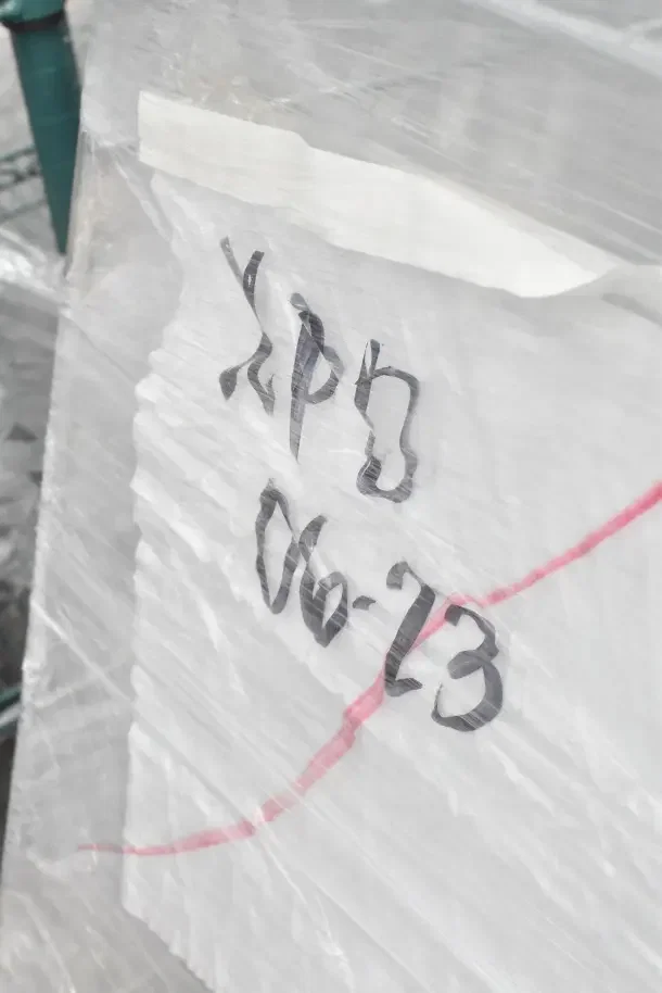 Plastic-wrapped package labeled "06-23," for Regency 6.3 Cu. Ft. supermarket shopping carts, scratch and dent condition, auctioned as new.