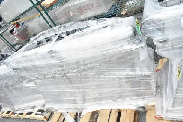 5 new Regency supermarket shopping carts, 6.3 cu. ft., wrapped for shipment. Condition labeled as scratch and dent.