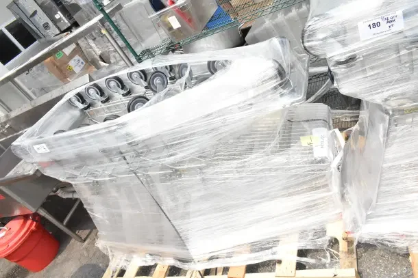 Brand new Regency supermarket shopping cart, 6.3 cu. ft., wrapped on a pallet. Scratch and dent condition, five carts included.