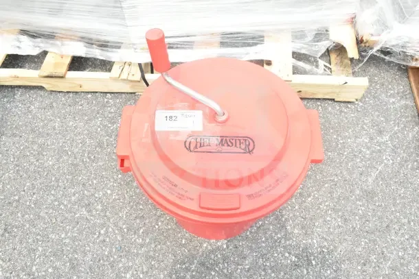 Chef Master red poly lettuce spinner with manual crank handle, visible branding on lid. Appears in used condition.
