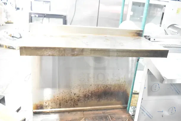 Vulcan commercial gas range with 4 burners, oven, overshelf, and backsplash. Visible wear and surface stains.