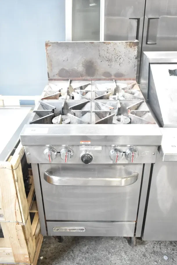 Southbend S241E commercial 4-burner gas range with oven, stainless steel, on casters. Visible wear on surface, control knobs intact.
