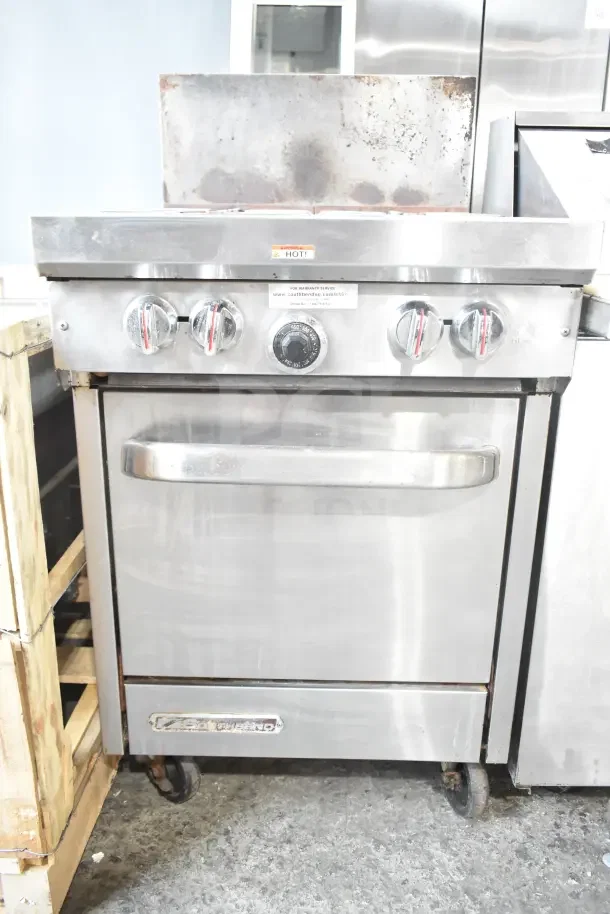 Southbend S241E commercial gas range, 4 burners, with oven, stainless steel, on casters, visible wear, model tag displayed.