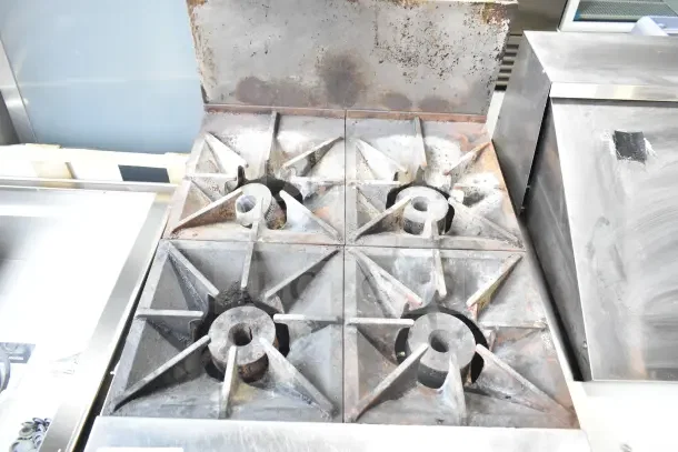 Southbend S241E commercial gas 4-burner range with oven; floor style on casters; visible wear; heavy-duty construction.