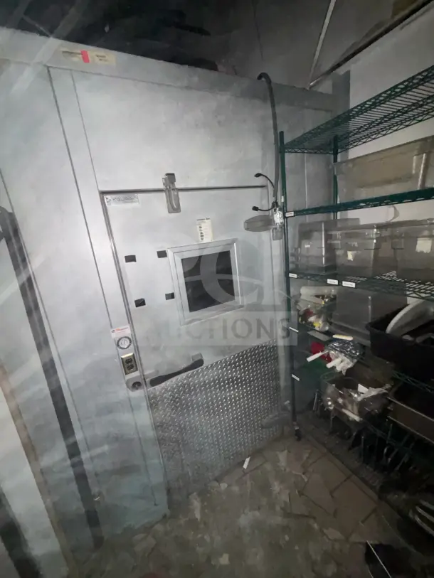 8'x12' walk-in box cooler with evaporator fan, featuring vented door and visible exterior markings, used condition.