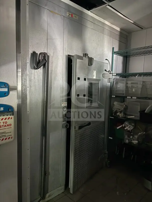 8'x12' walk-in box with evaporator fan, metal finish, visible control panel, condition prior to removal, does not include contents.