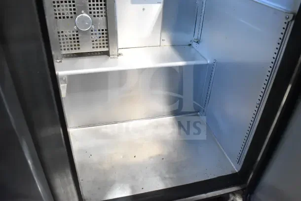 2018 True TSSU-72-30MB-ST-HC sandwich prep table interior view, showing clean metal shelving and side panels.