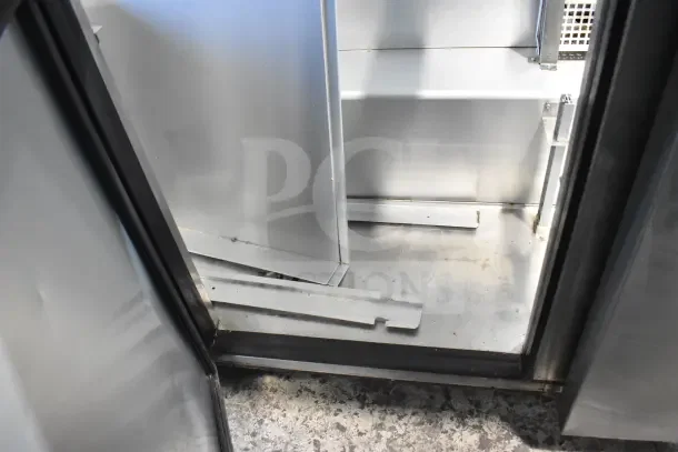 2018 True TSSU-72-30MB-ST-HC sandwich prep table interior view, showing stainless steel shelves, slight wear. Model label visible.