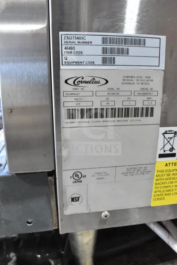 Cornelius DF200-BC beverage machine label showing model, part number, voltage, certification marks, and safety instructions.