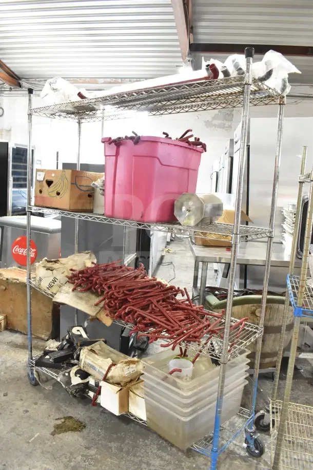 Metro shelving unit with red poly bins, metal shelves, and contents. Includes red units. Buyer must dismantle.