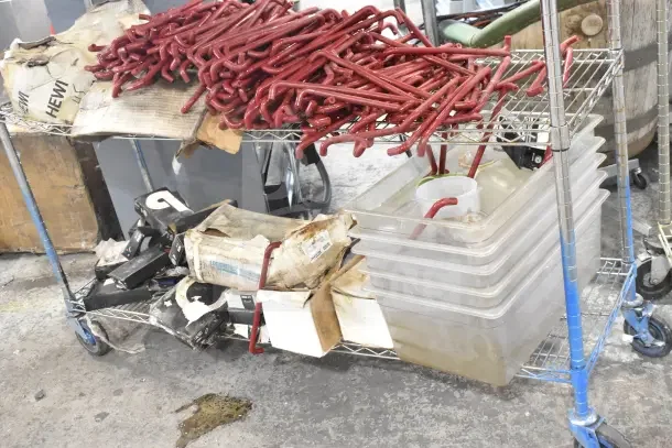 Metro shelving unit with contents, including multiple red poly bins and metal shelves. Buyer must dismantle.
