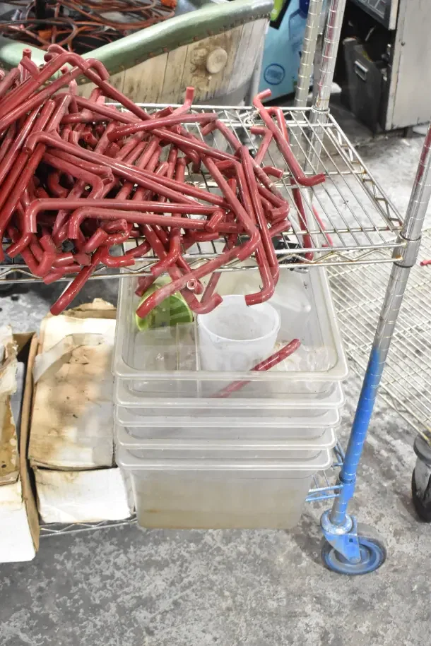 Metro wire shelving unit with poly bins, red units, and caster wheels. Requires dismantling for shipping. Consider freight costs.