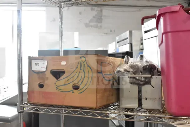 Metro shelving unit with contents including poly bins, red units, and banana box. Buyer must dismantle.