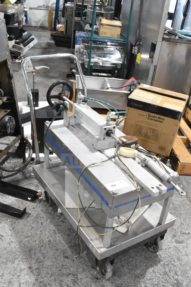 Geyer Portable System on casters, sturdy metal frame, steering wheel, control rods, and visible wiring; item label shows "187."