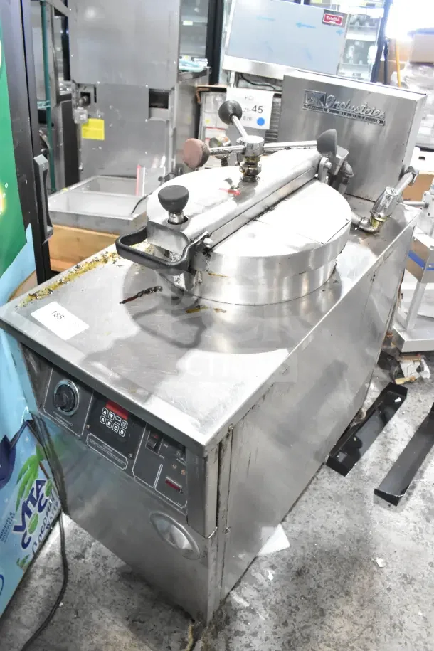 BK Industries commercial floor-style pressure fryer on casters, stainless steel, used condition, control panel visible.