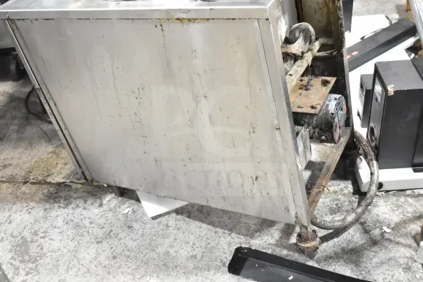 BK Industries commercial pressure fryer on casters, showing signs of wear and use, with visible grease and rust.