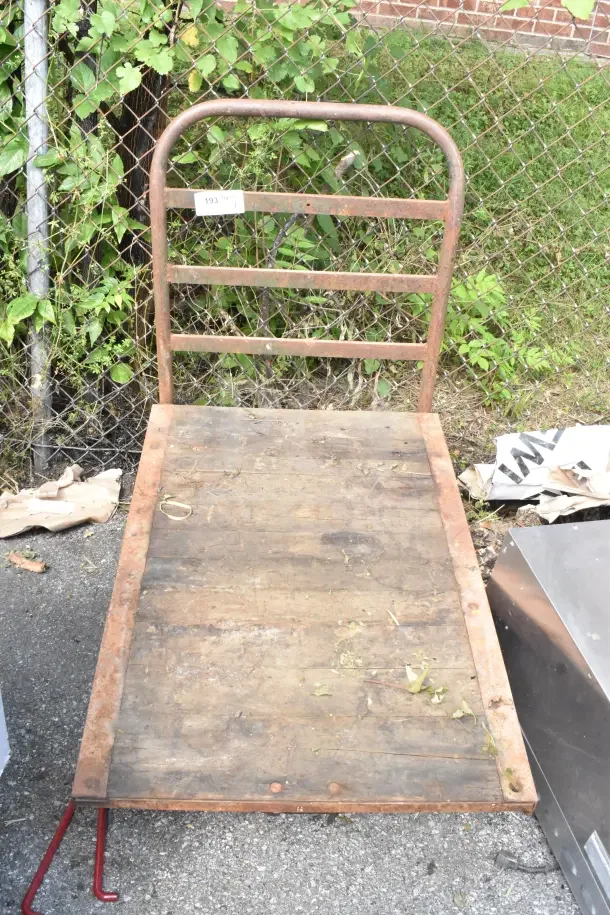 Flat top cart with sturdy frame on commercial casters. Wooden surface shows wear. Label marked "193" visible.