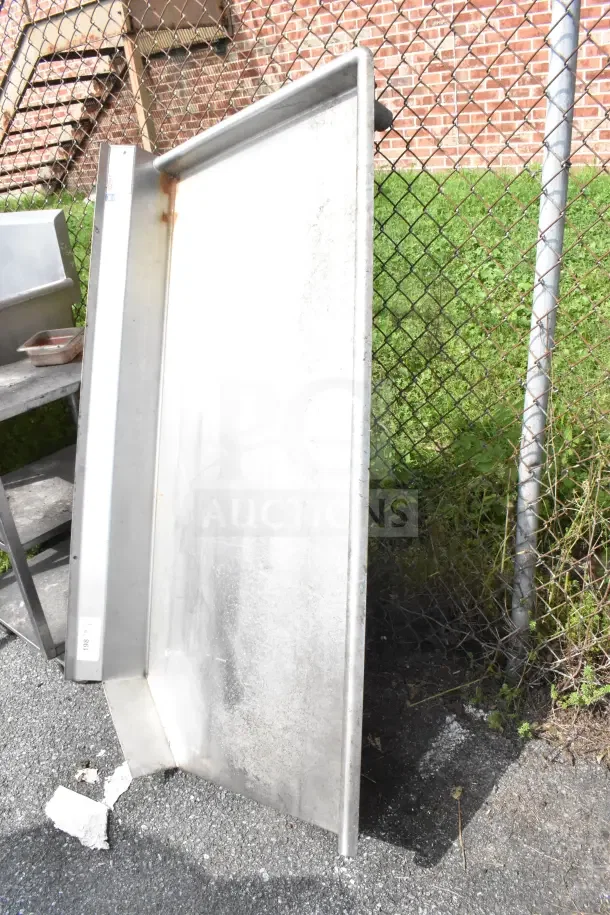 Eagle Commercial Right Side Clean Side Dishwasher Table, metal surface, no legs, outdoors, visible wear.