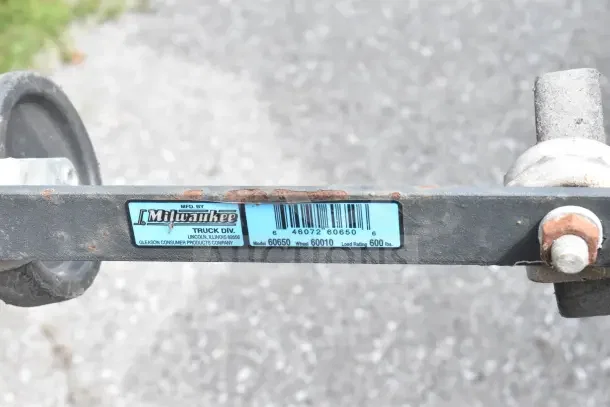Milwaukee furniture dolly, model 60650, 600 lb load rating, visible wear and rust, label from Gleason Consumer Products.