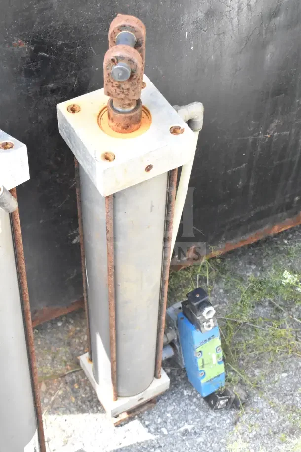Miller W AL84B2B pneumatic cylinder, showing visible wear and rust, with connected wiring and mounting hardware.