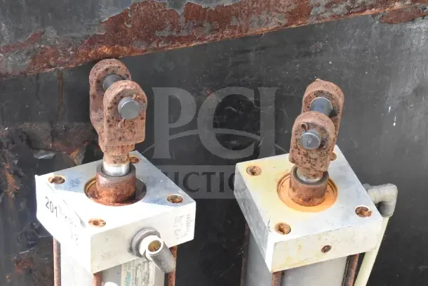 Two Miller W AL84B2B pneumatic cylinders with visible rust and wear. Marked "2011 Korry x2" on base.
