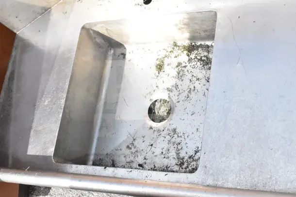 Commercial right side dirty dishwasher table without legs; stainless steel, visible wear, integrated sink basin.