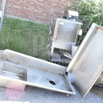Jackson Conserver XL commercial dishwasher with stainless steel tables, showing visible wear. Model markings visible.